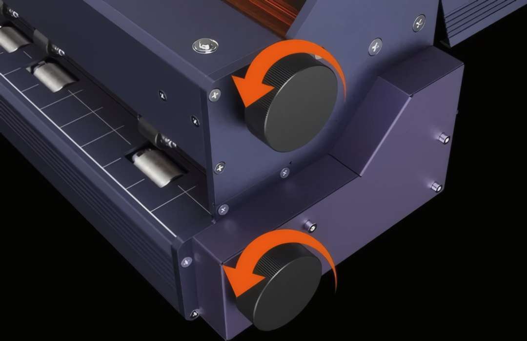 Adjustment knobs with orange rotation-direction arrows on the device frame