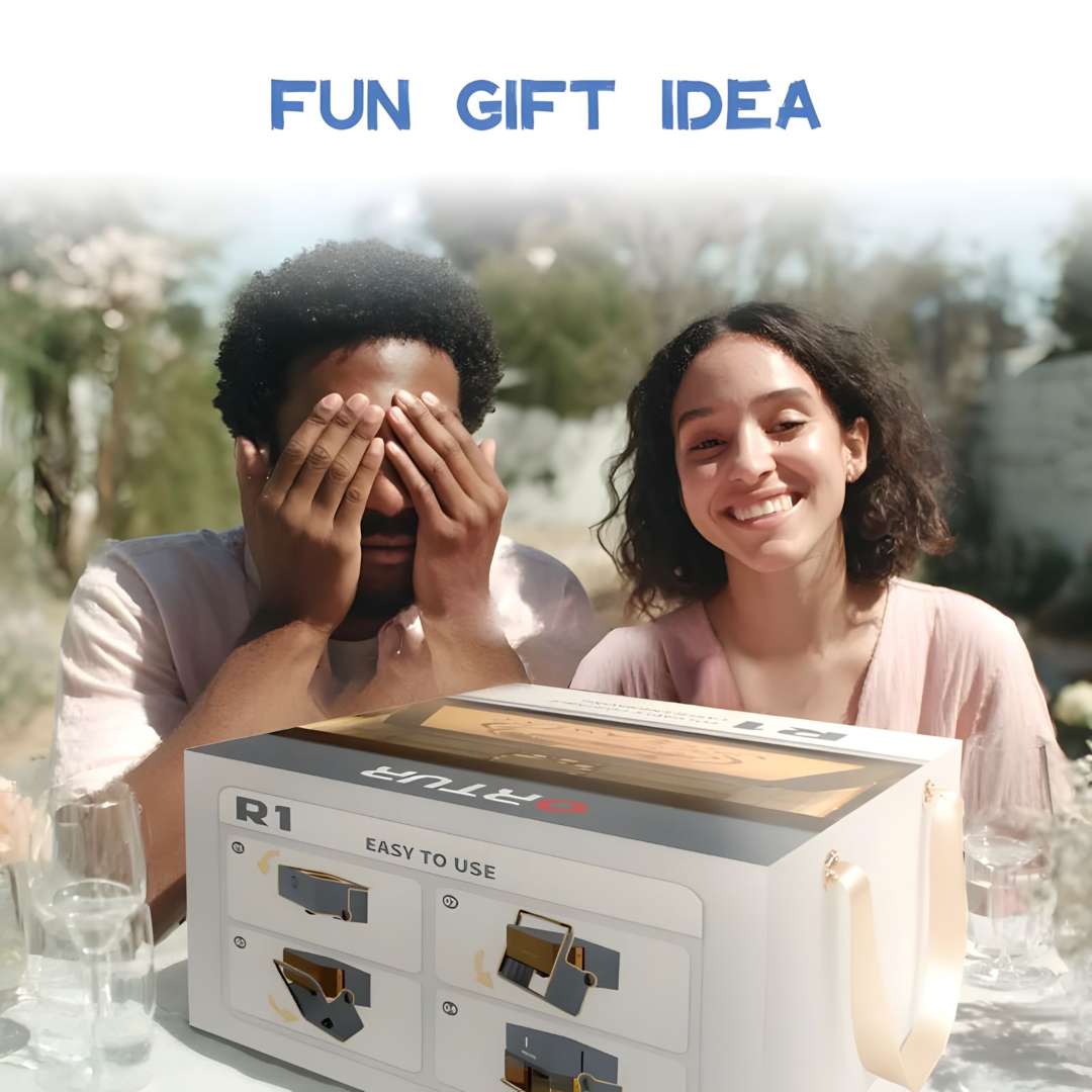 Ortur R1 laser engraver in its gift-ready retail box at an outdoor social setting, two people reacting with surprise and excitement to the gift reveal