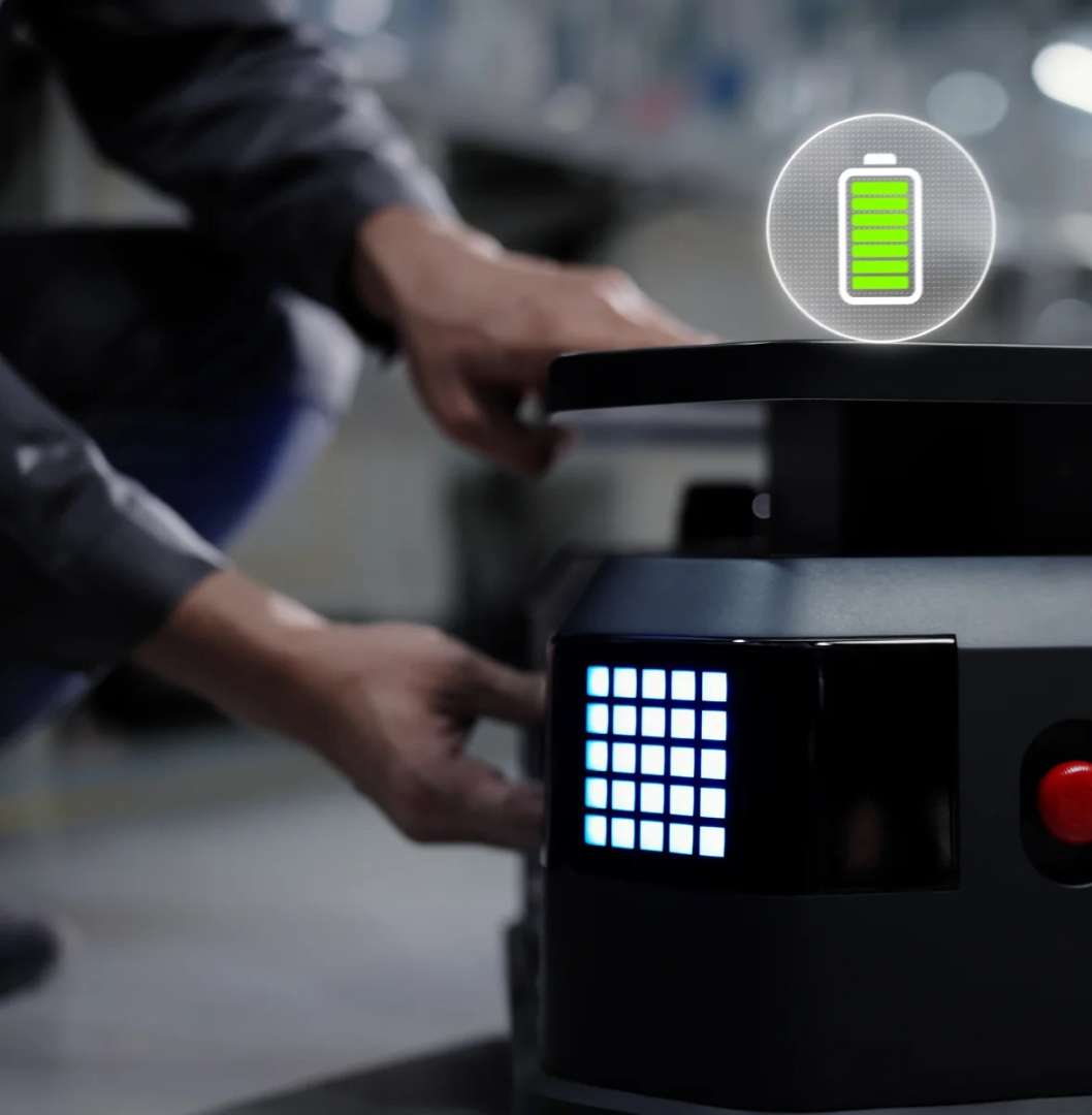 Operario realizando un cambio rápido de batería en el PUDU T300, con indicador de batería completa visible sobre el robot