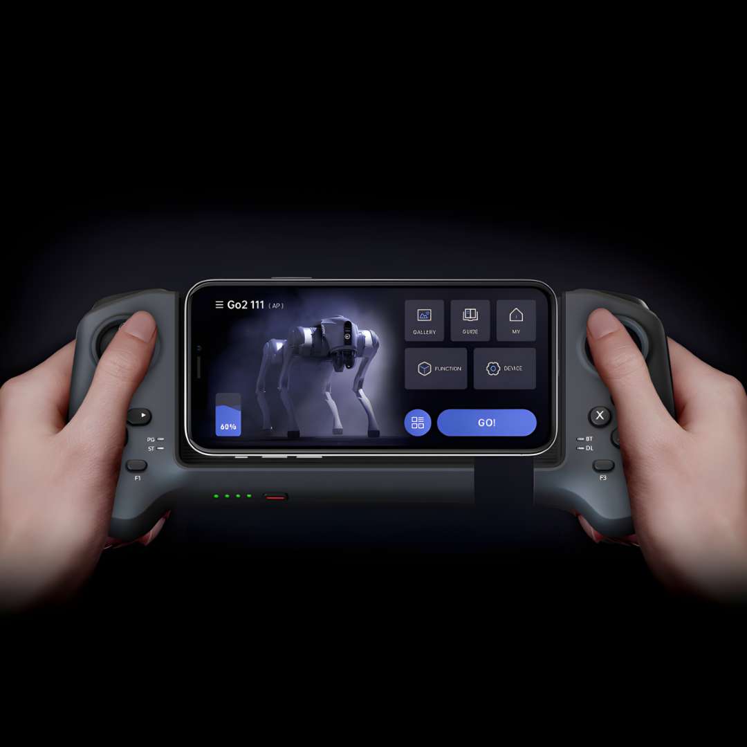 Hands holding Unitree R3 remote control with smartphone mounted showing Go2 live camera feed and Unitree Go App control interface