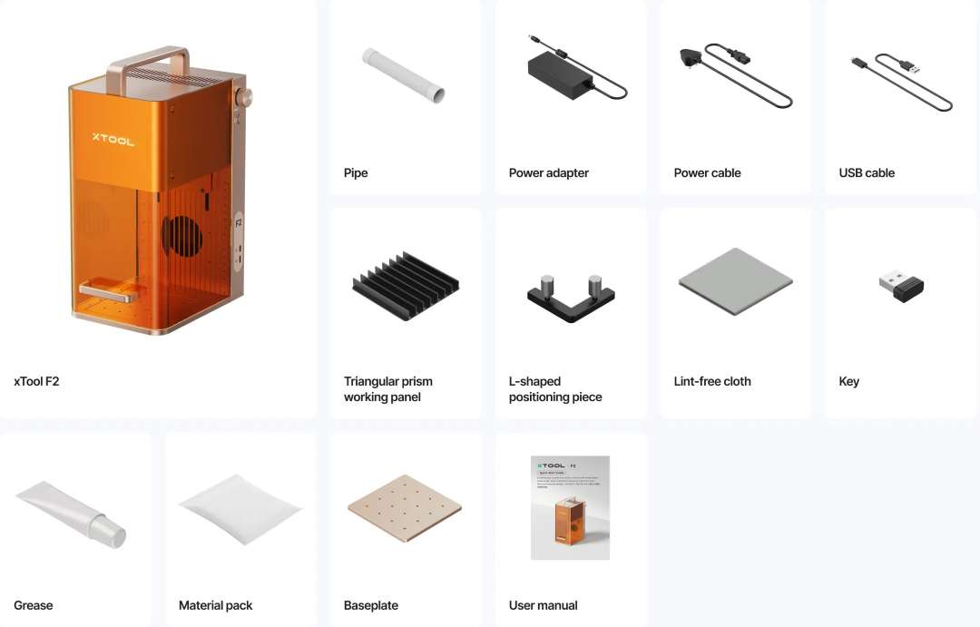 xTool F2 laser engraver alongside box contents: cables, work panel, base, and user guide